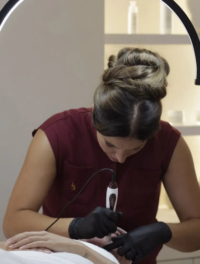 Charlotte performing a skin treatment in her Portsmouth clinic